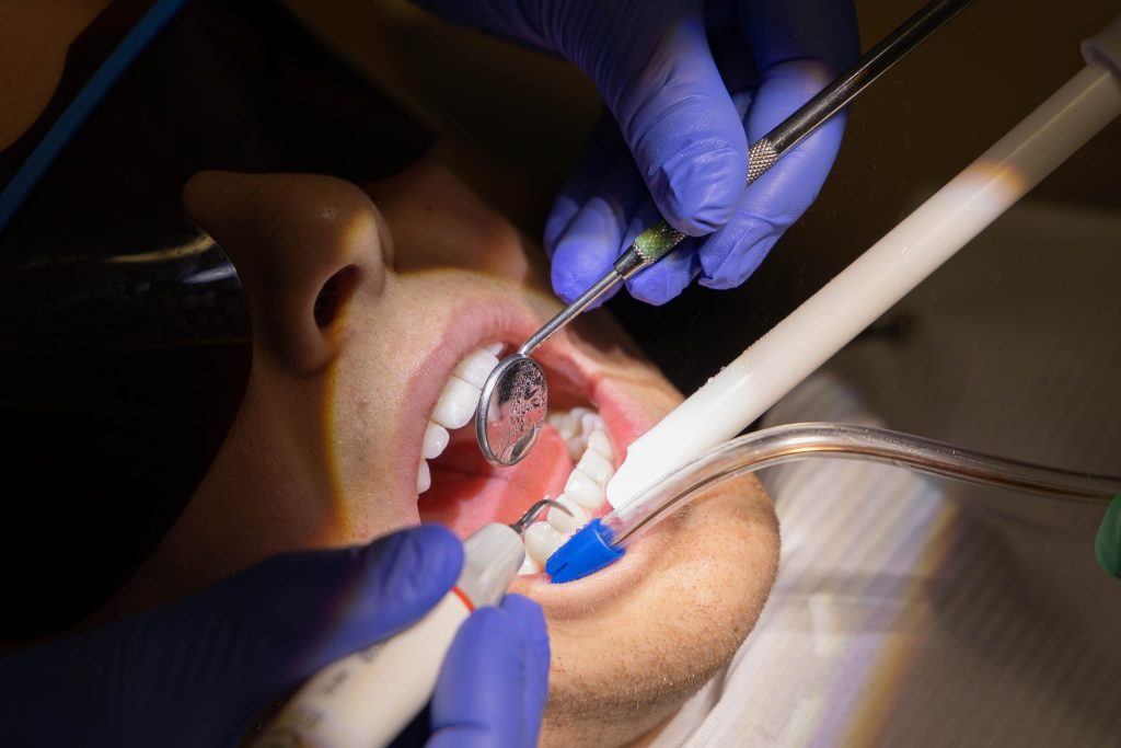 dentist performing an emergency procedure on a patient’s tooth